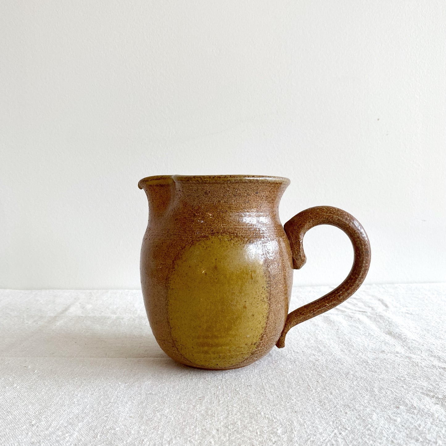 Handcrafted Pottery Pitcher with Yellow Detail