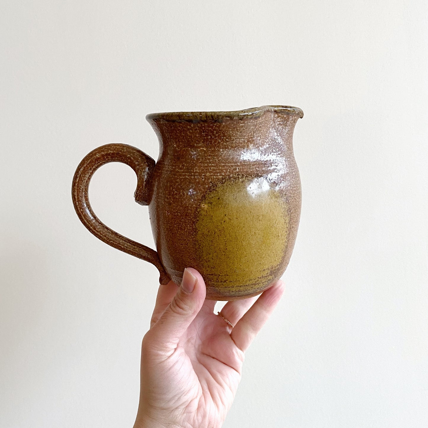 Handcrafted Pottery Pitcher with Yellow Detail