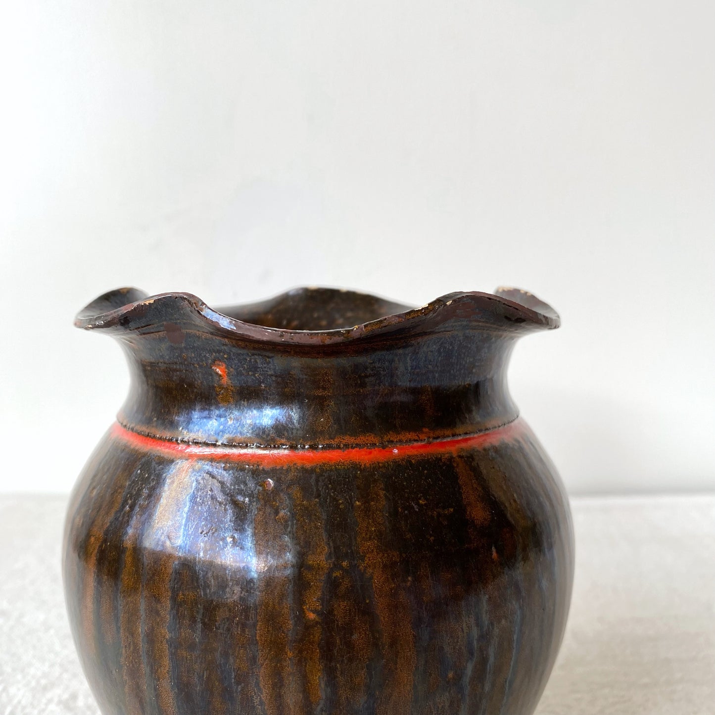 Vintage Black and Red Pottery Vessel with Ruffle Lip
