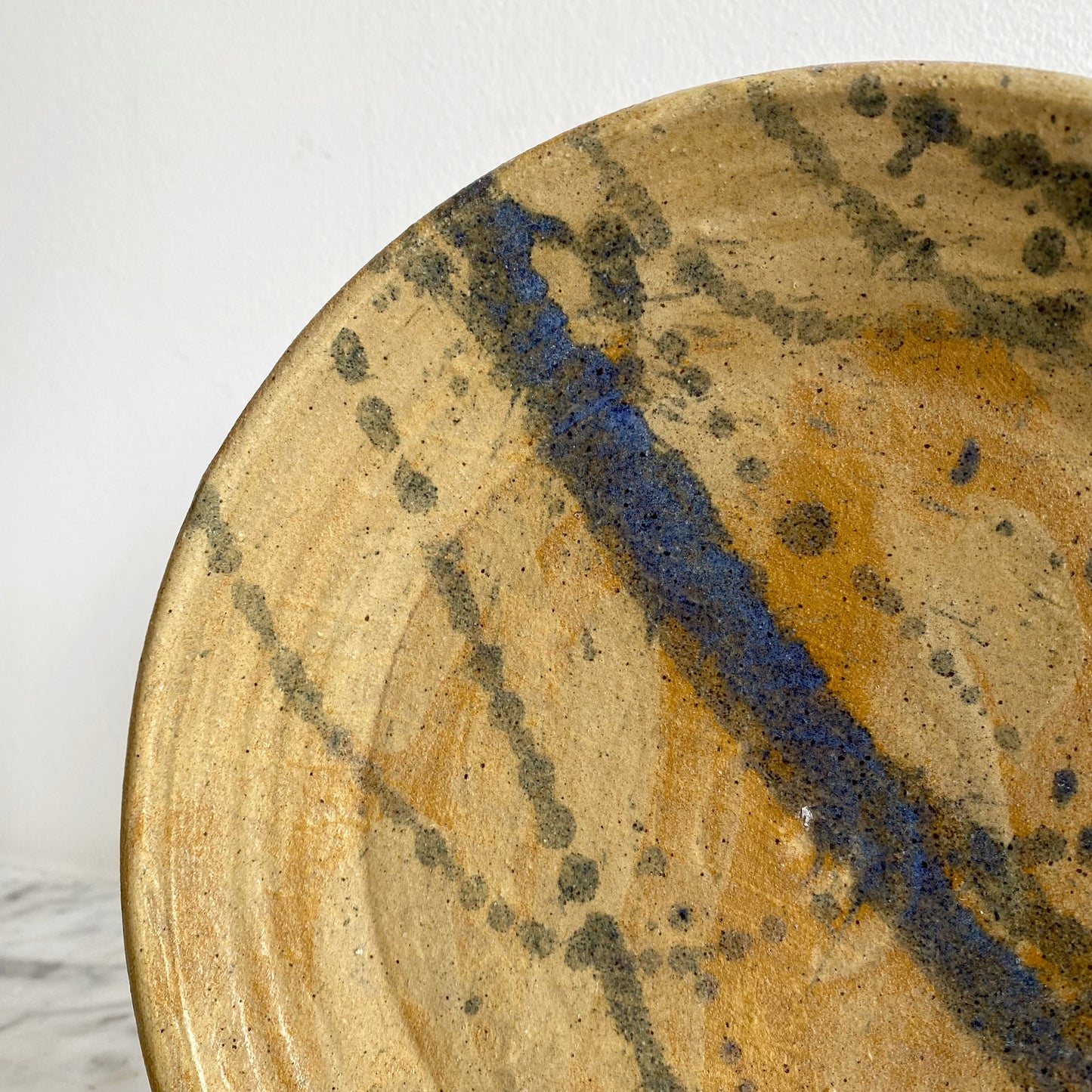 Vintage Pottery Plate with Blue Splatter Design